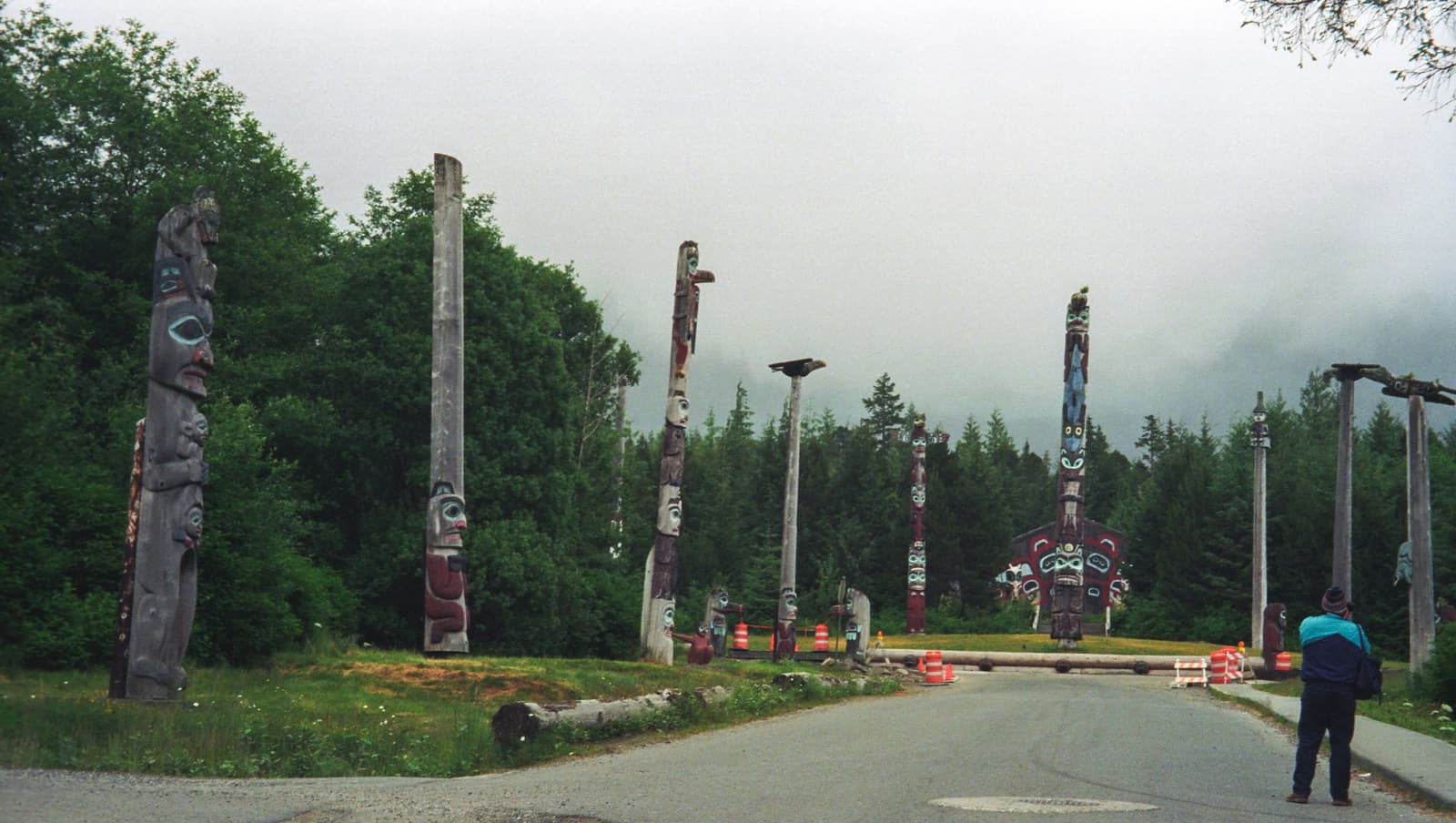 Totem poles lining the road to the clan house at Saxman Totem Park