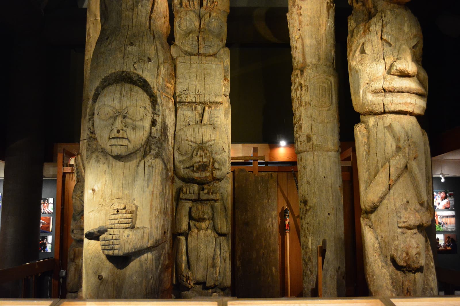 Weathered nineteenth-century totem poles displayed inside the Totem Heritage Center