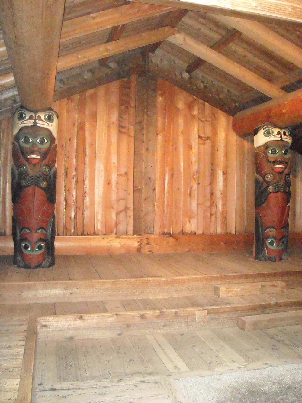 Carved house posts inside the clan house at Totem Bight