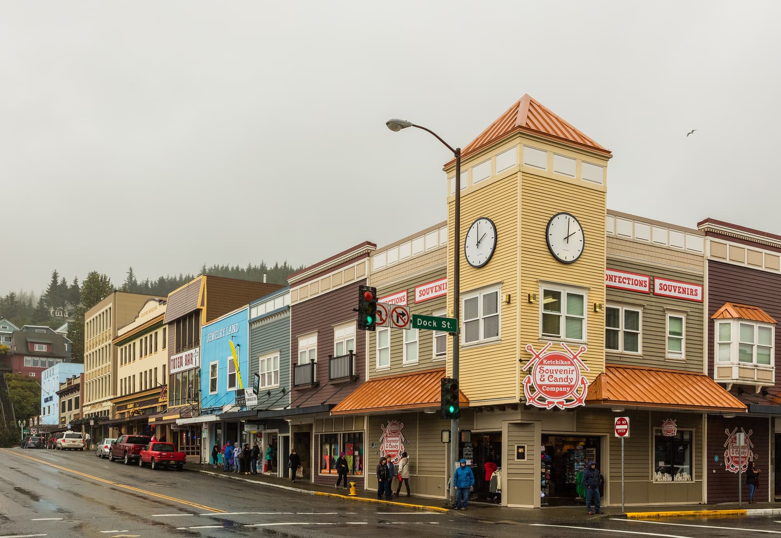A wet street corner in downtown Ketchikan under grey skies
